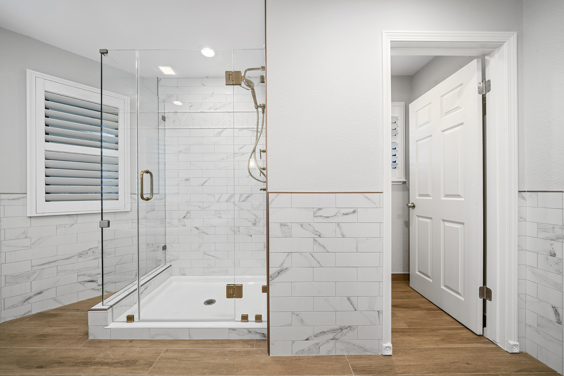 Frameless glass shower with bronze fixtures in Sacramento CA 95825