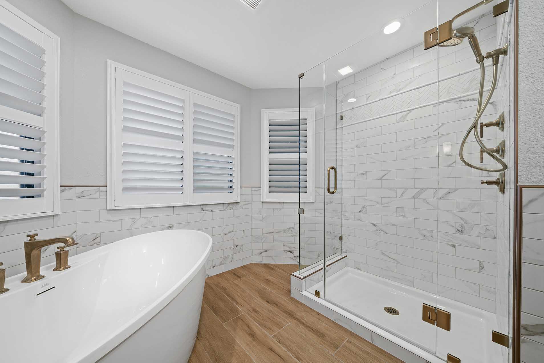 Freestanding tub and frameless shower with bronze fixtures in Sacramento CA 95825 bathroom