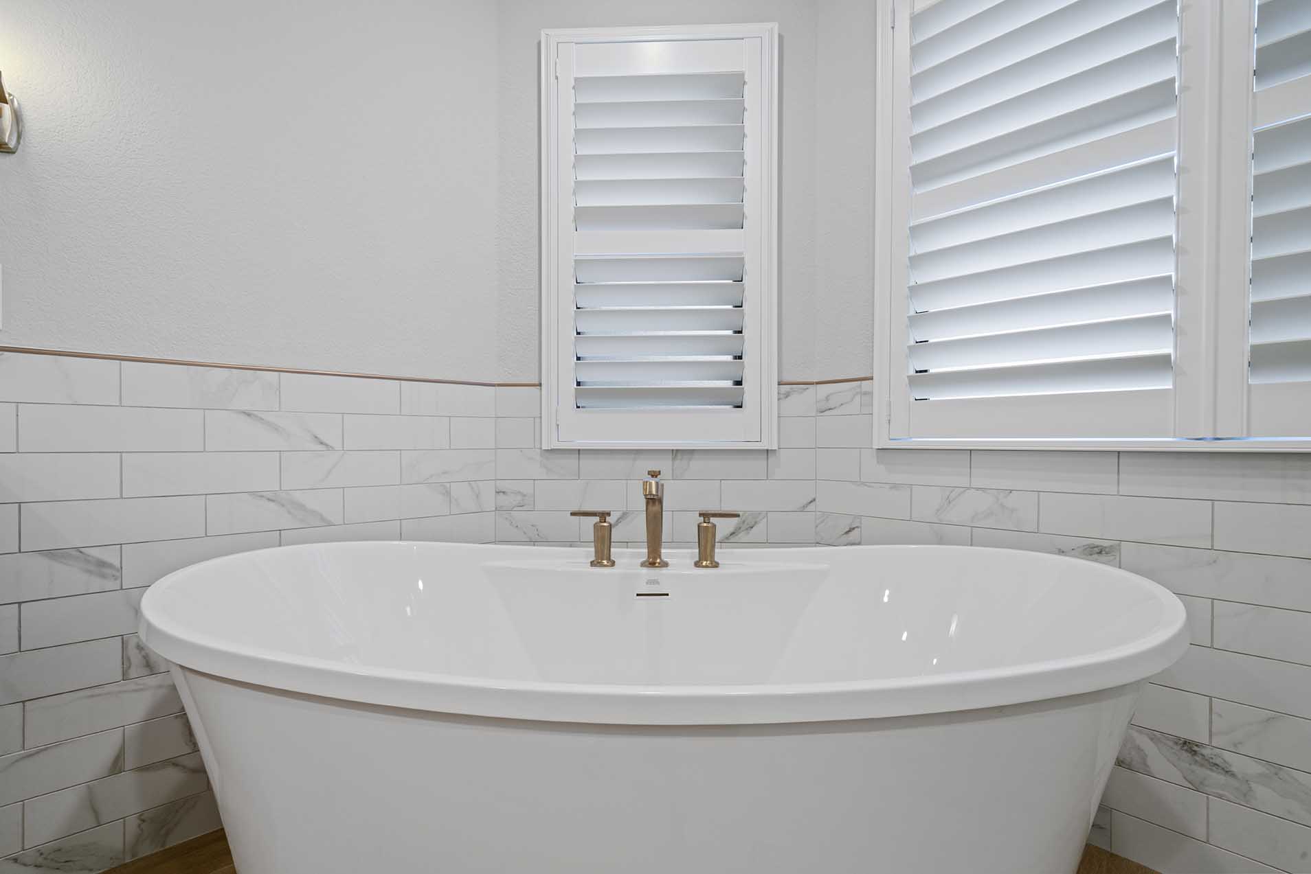 Freestanding tub with bronze fixtures in remodeled bathroom in Sacramento CA 95825