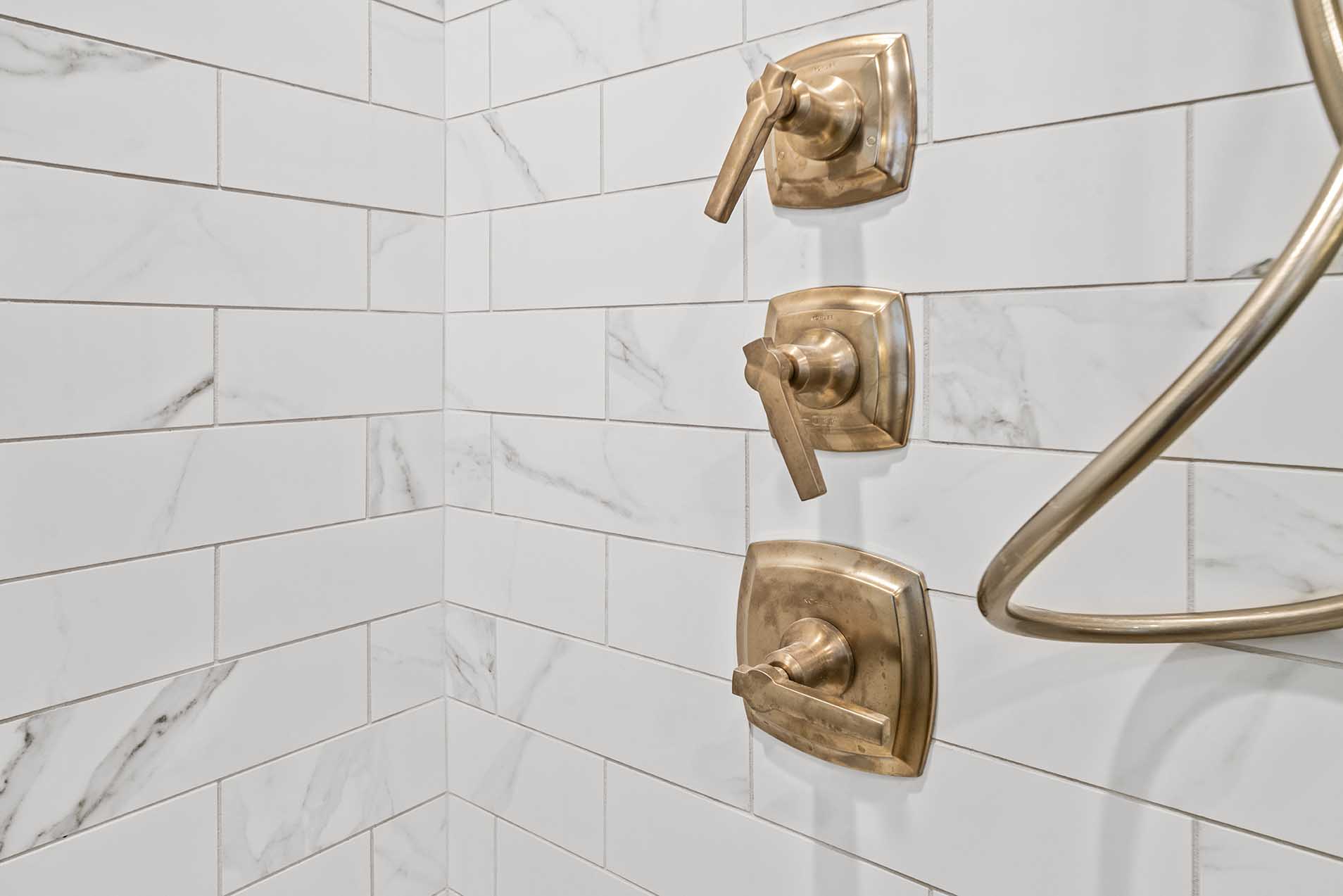 Remodeled shower with bronze hardware