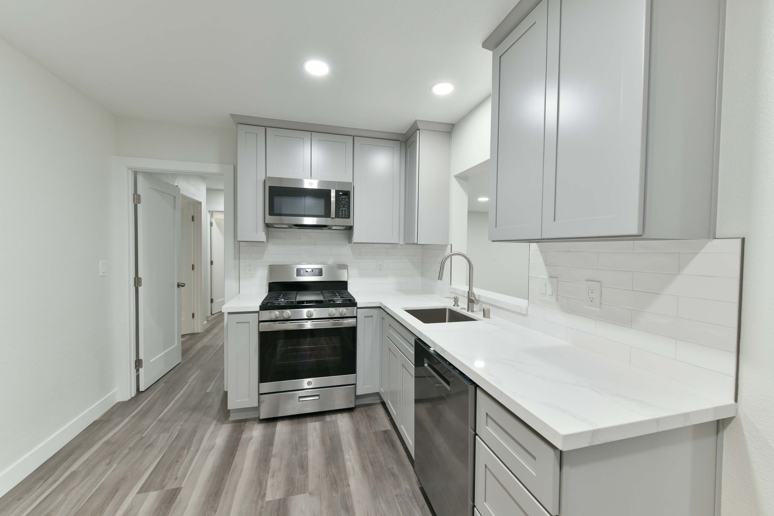 Functional kitchen redesign highlighting improved workflow between the sink, range, and prep surfaces, finished with quartz countertops and soft-close cabinetry.