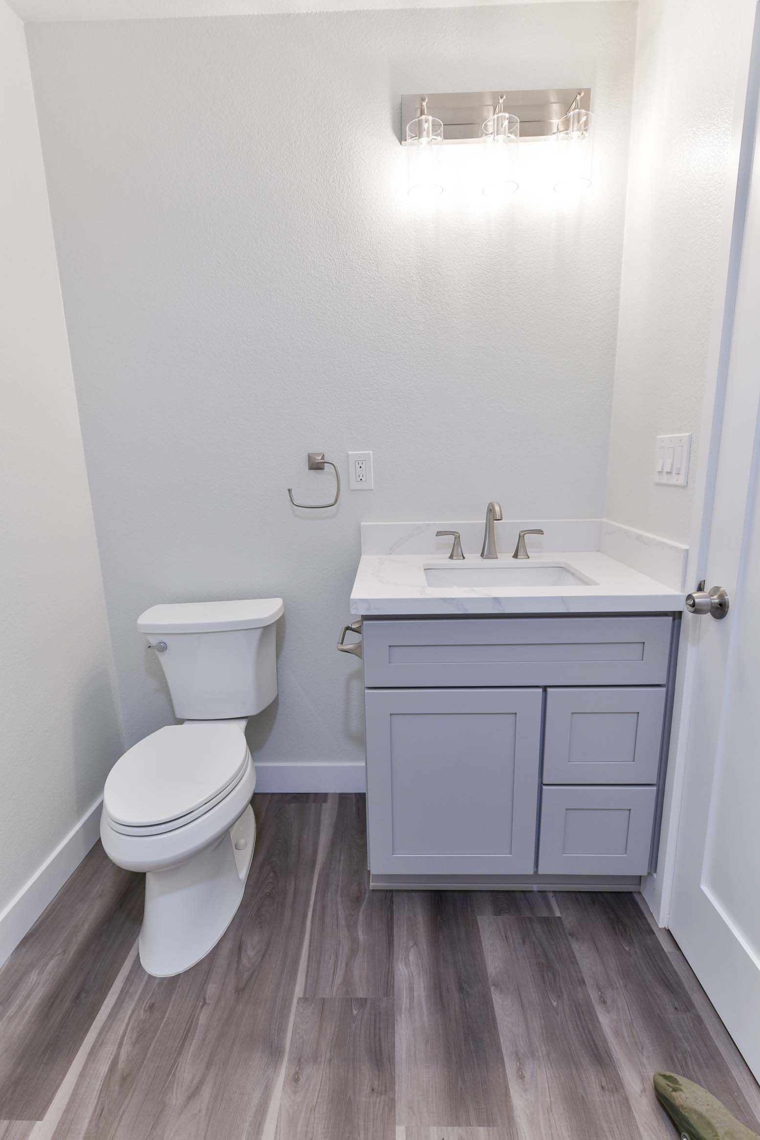 Modern vanity lighting paired with neutral finishes.