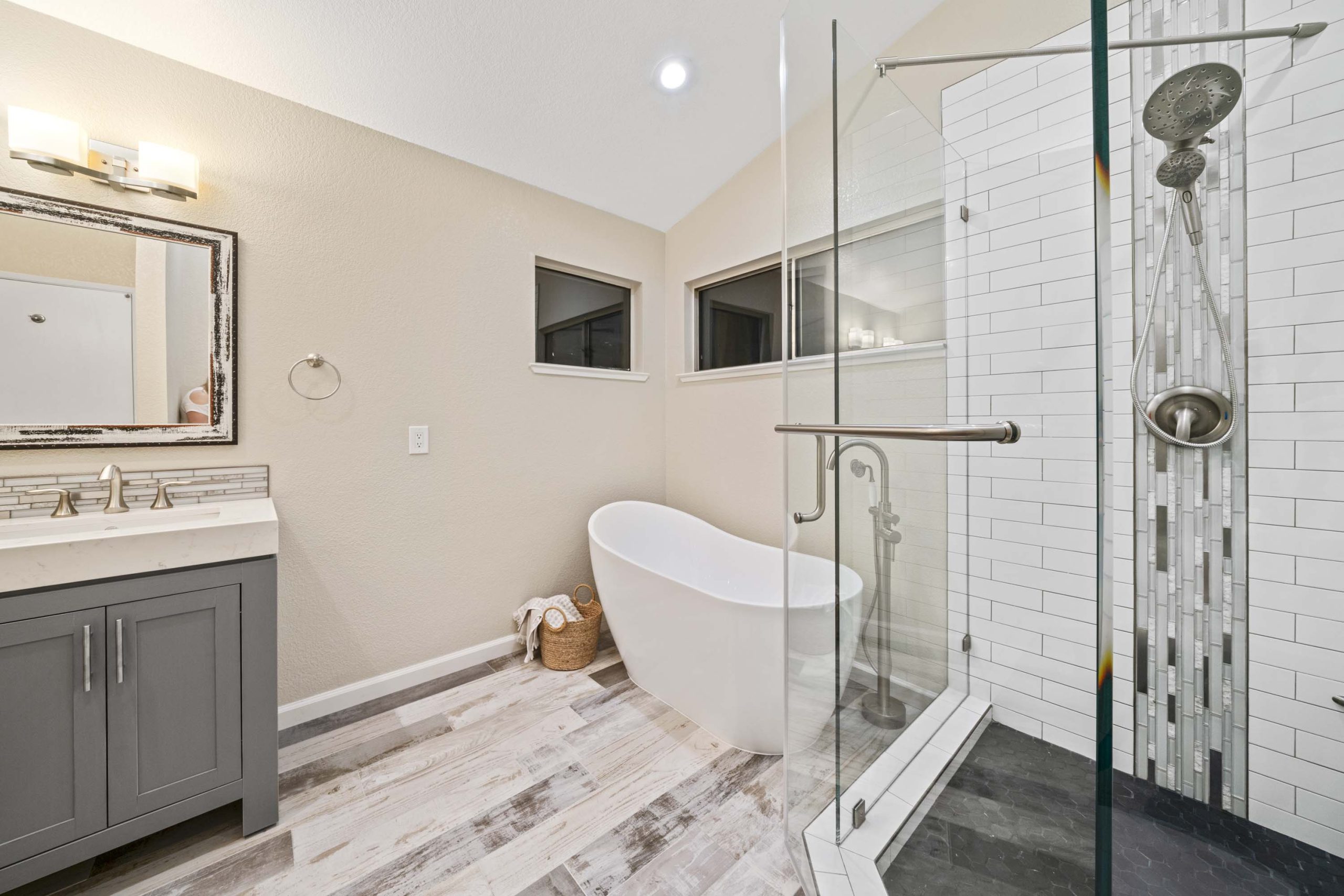 Freestanding tub adjacent to glass-enclosed walk-in shower in Roseville, CA 95678