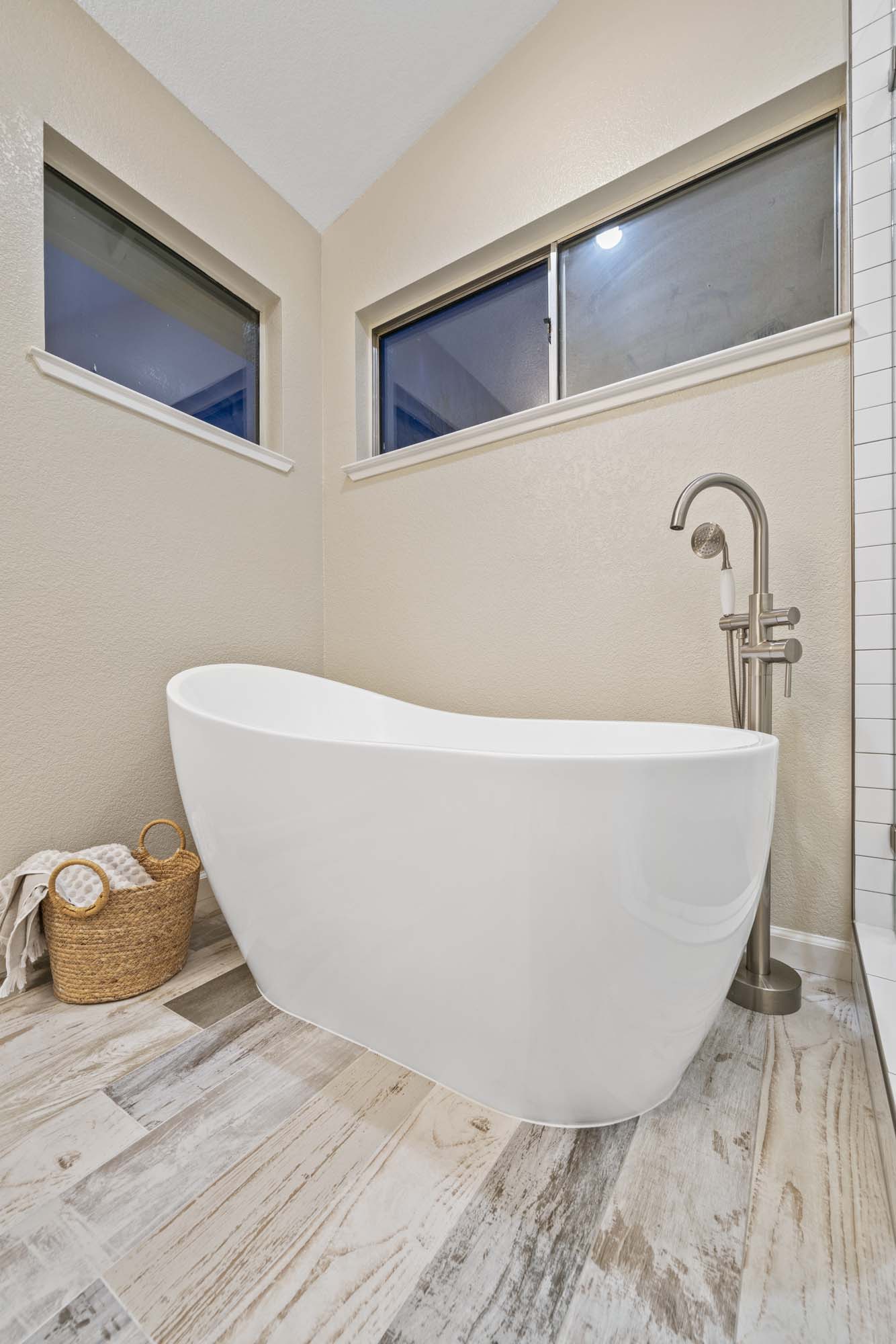 Freestanding tub over porcelain tile flooring in Roseville, CA 95678