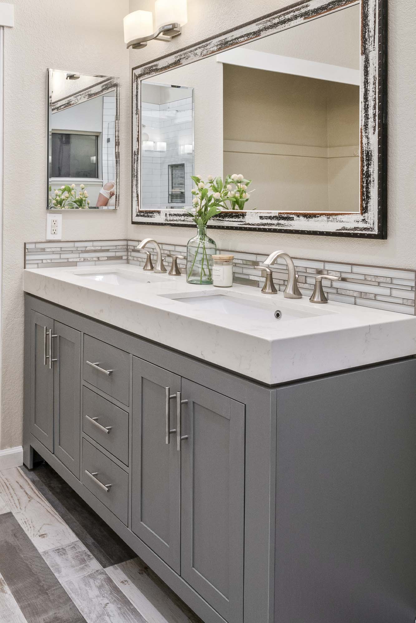 Vanity countertop detail with undermount sinks and wall-mounted lighting in Roseville, CA 95678