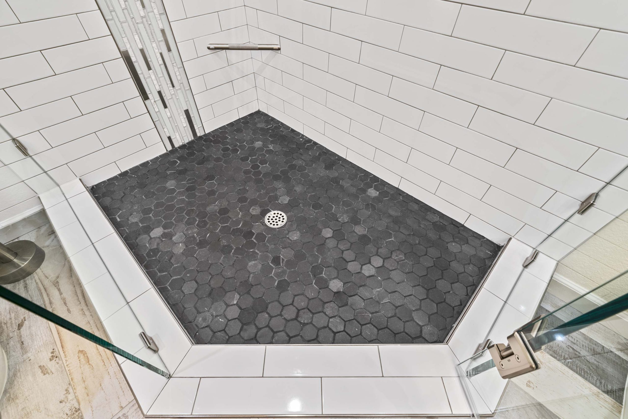 Walk-in shower floor with hex tile and centered drain in Roseville, CA 95678