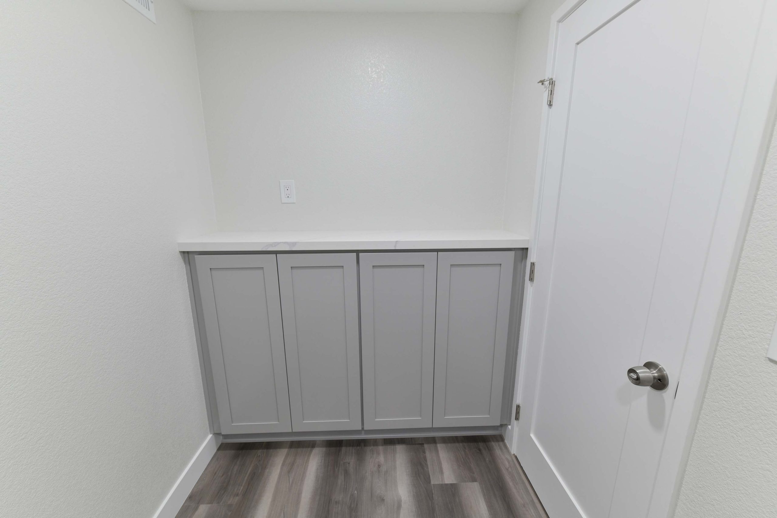Built-in storage cabinet with countertop and clean, modern finishes.