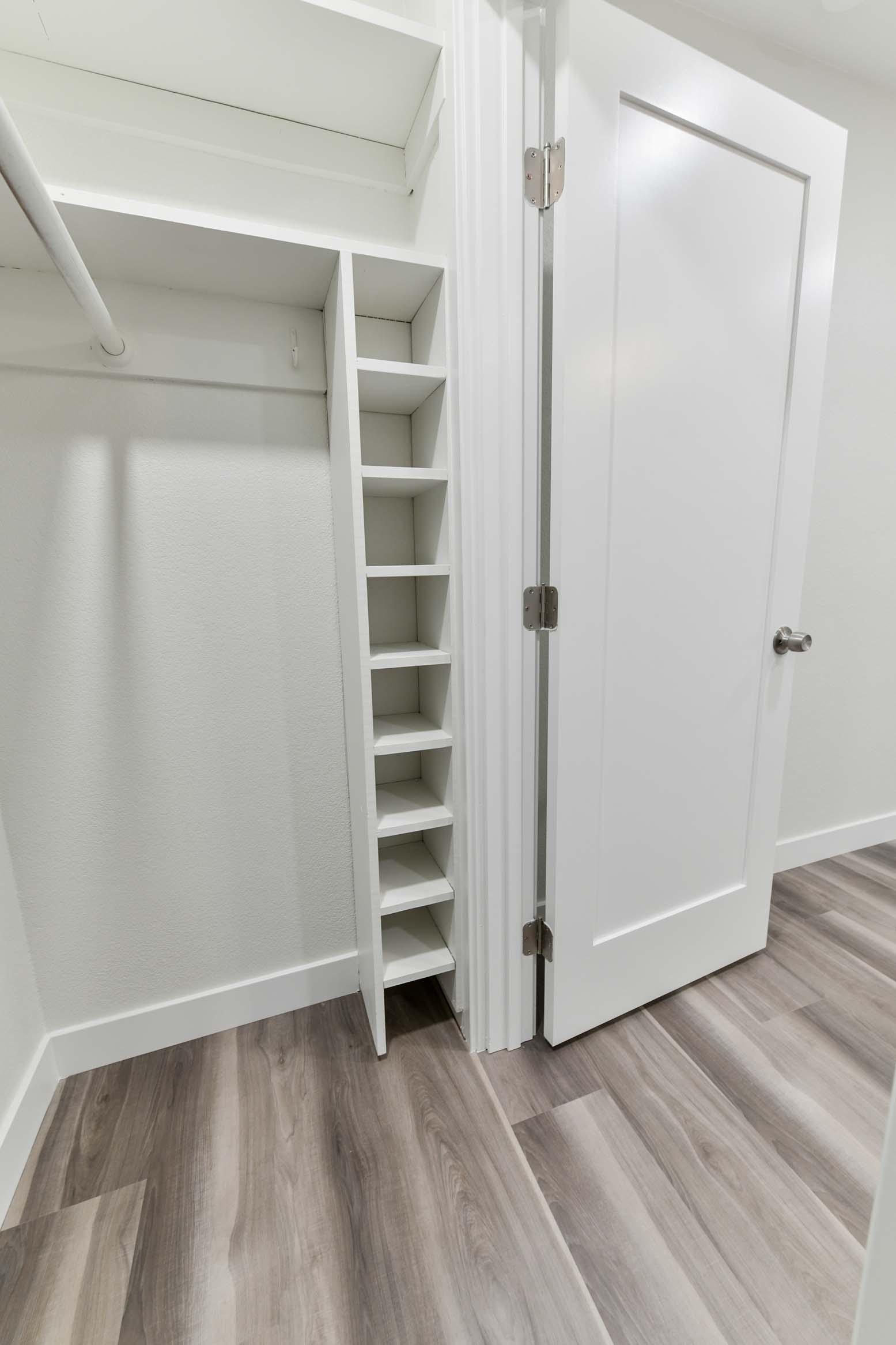 Compact closet layout with added shelving and clean finishes.