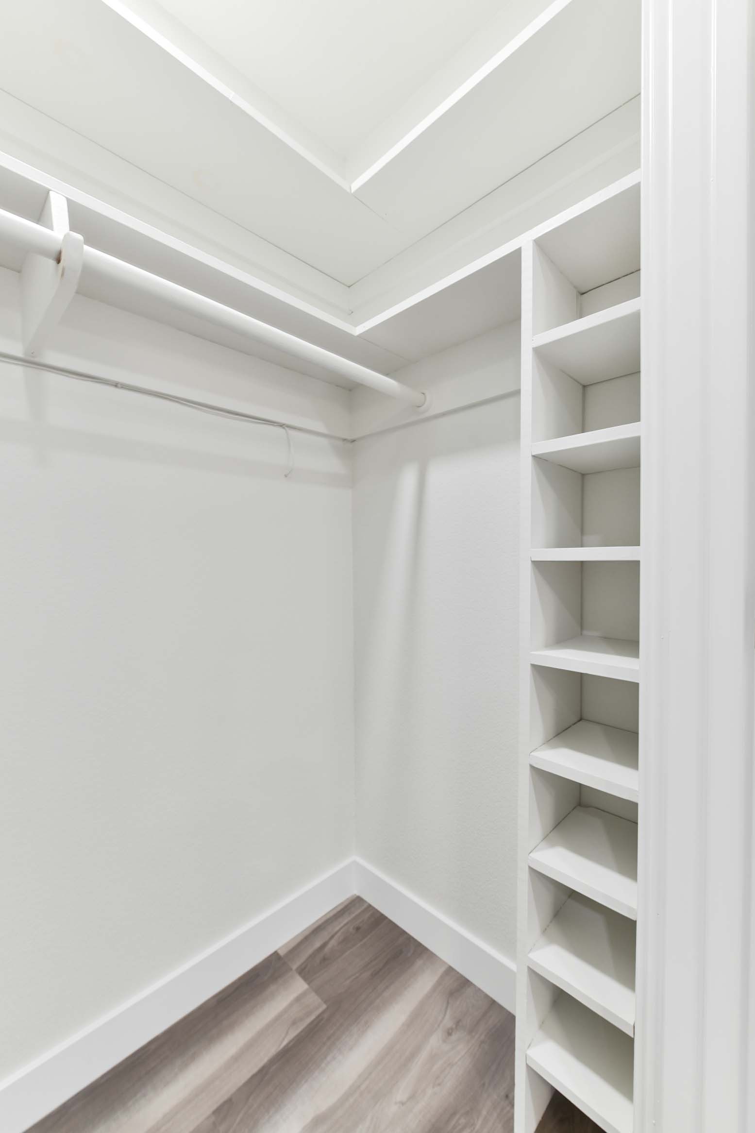 Custom closet shelving with built-in storage and hanging space.