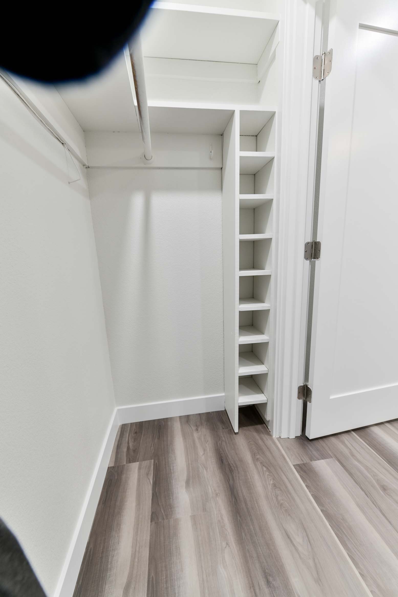 Updated walk-in closet with improved storage and layout.