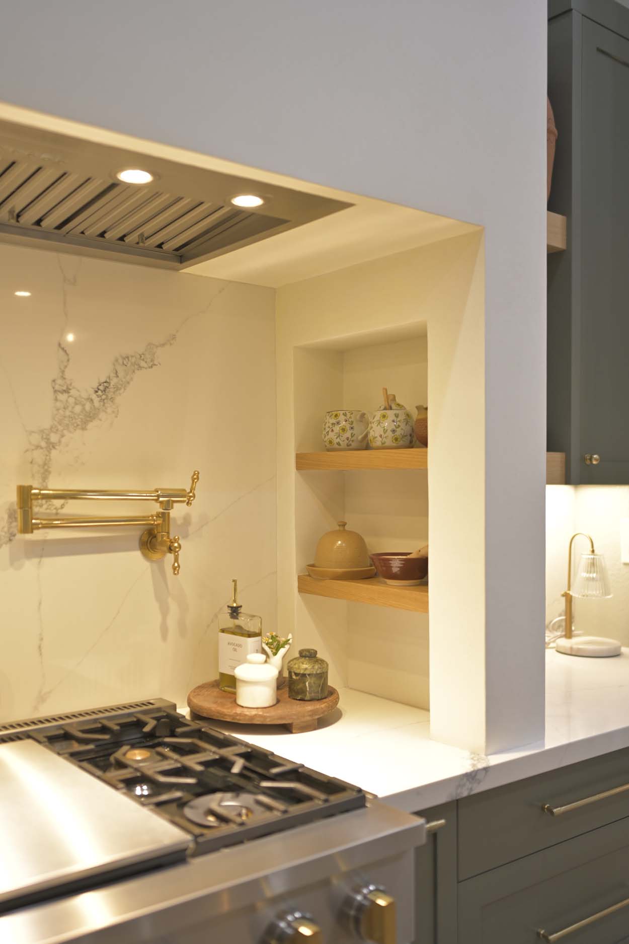 Kitchen remodel in Elk Grove, CA 95758 featuring a brass pot filler, open shelving, and a custom range wall.