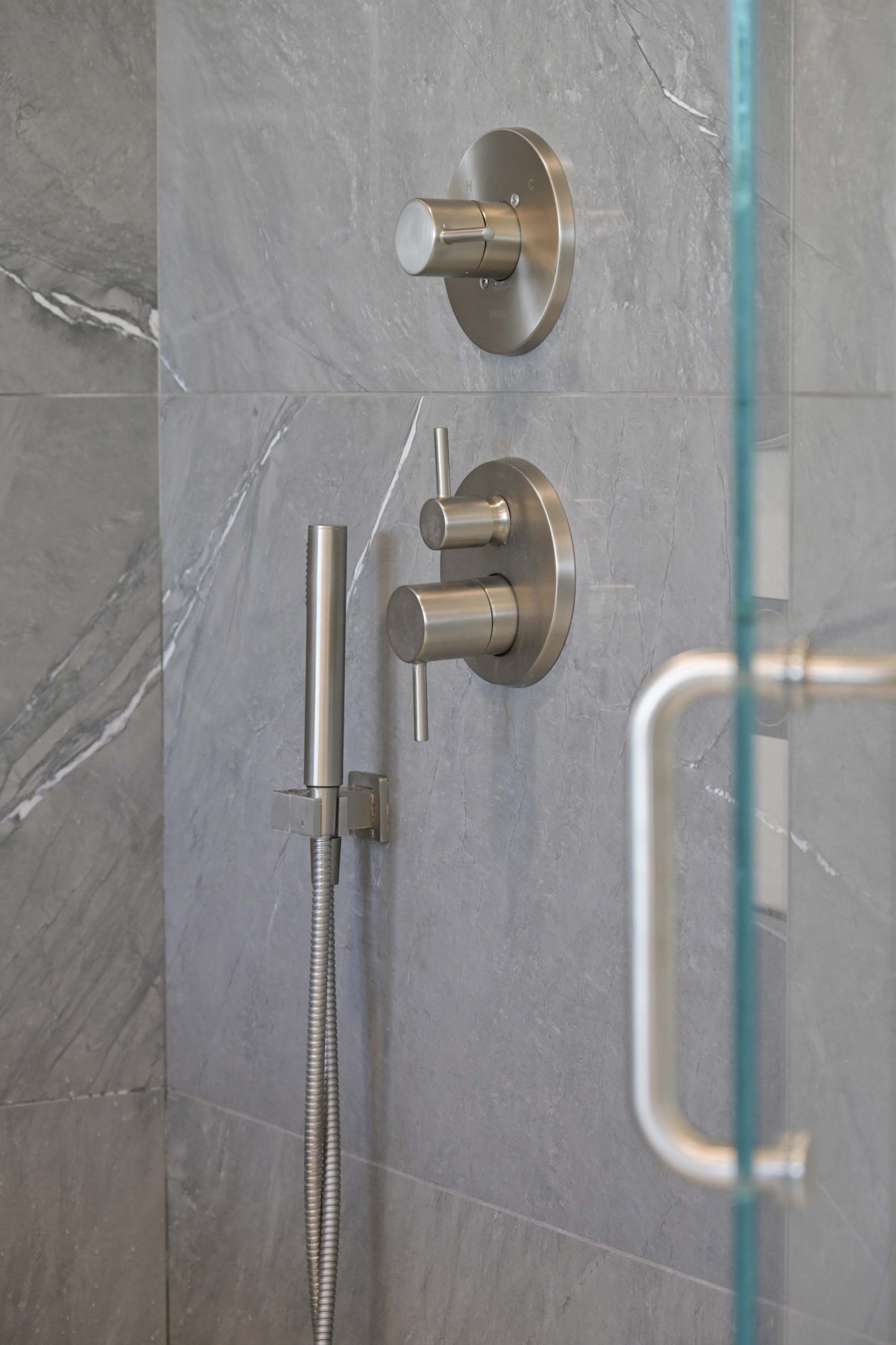 Brushed nickel shower fixtures and gray wall tile in a master bathroom remodel in Rocklin, CA 95765