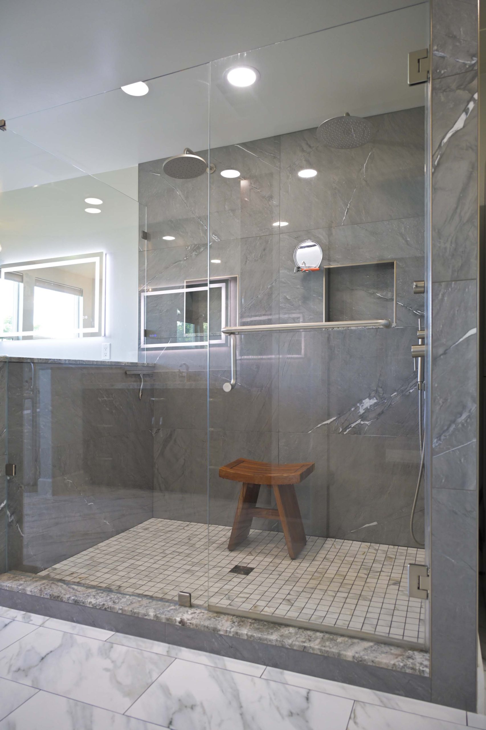Frameless glass walk in shower with large format gray tile and bench in Rocklin, CA 95765