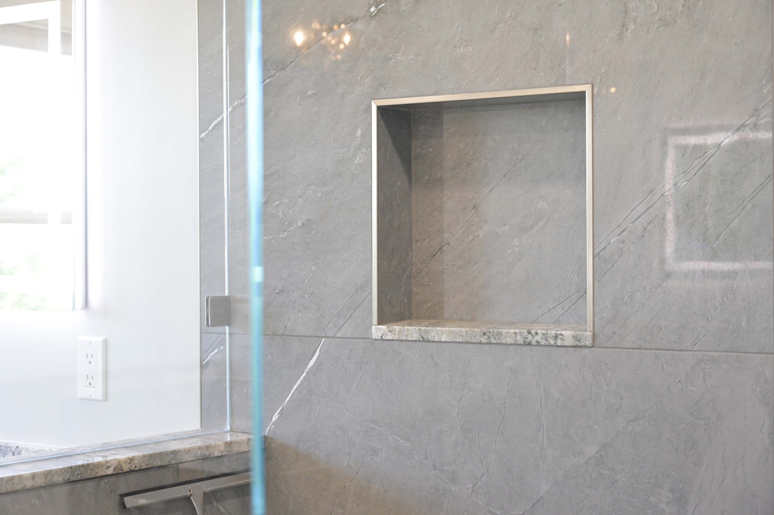 Recessed shower niche with large format gray wall tile in a master bathroom remodel in Rocklin, CA 95765