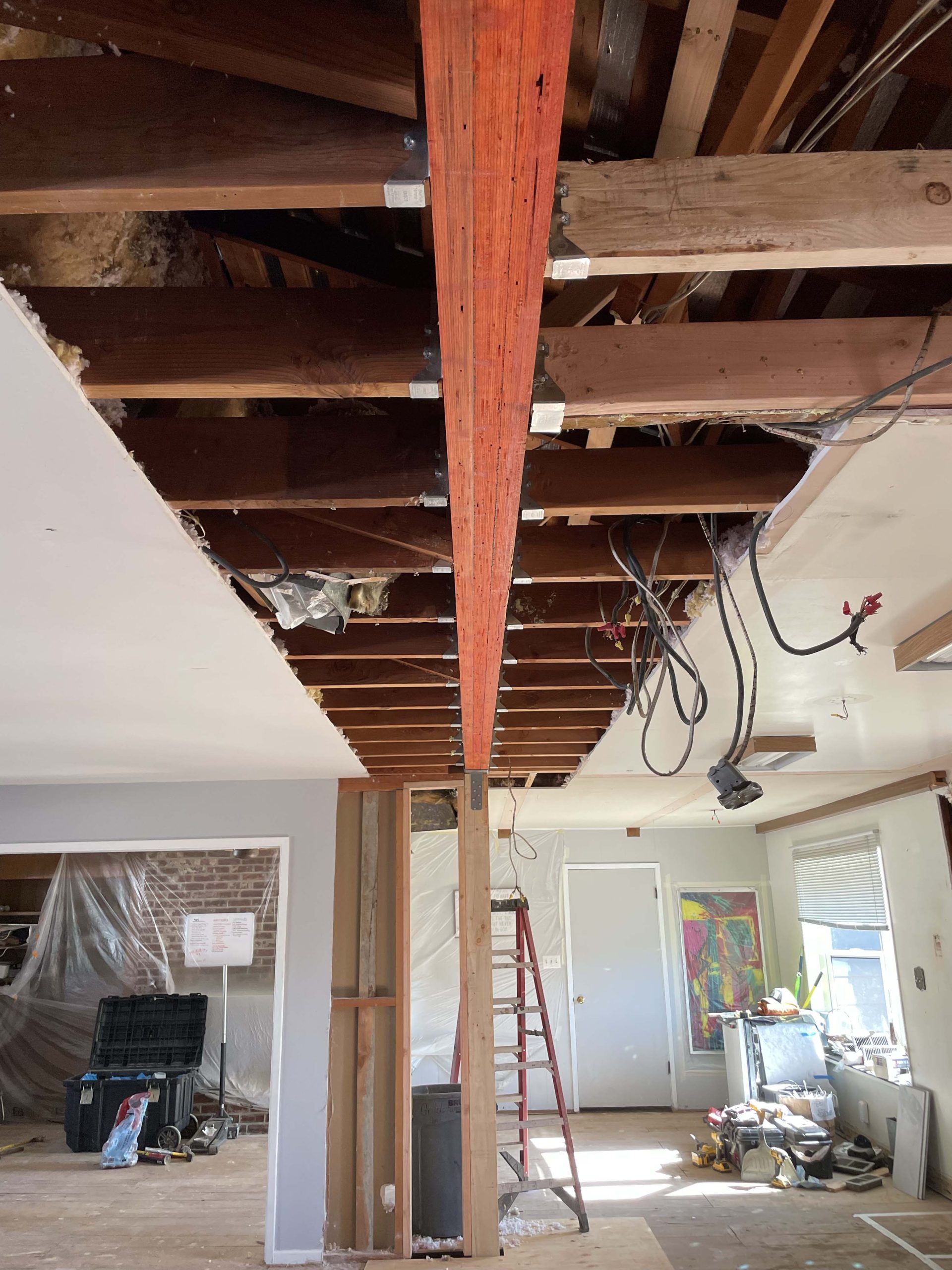 New structural beam and temporary supports holding the ceiling while the load-bearing wall was removed