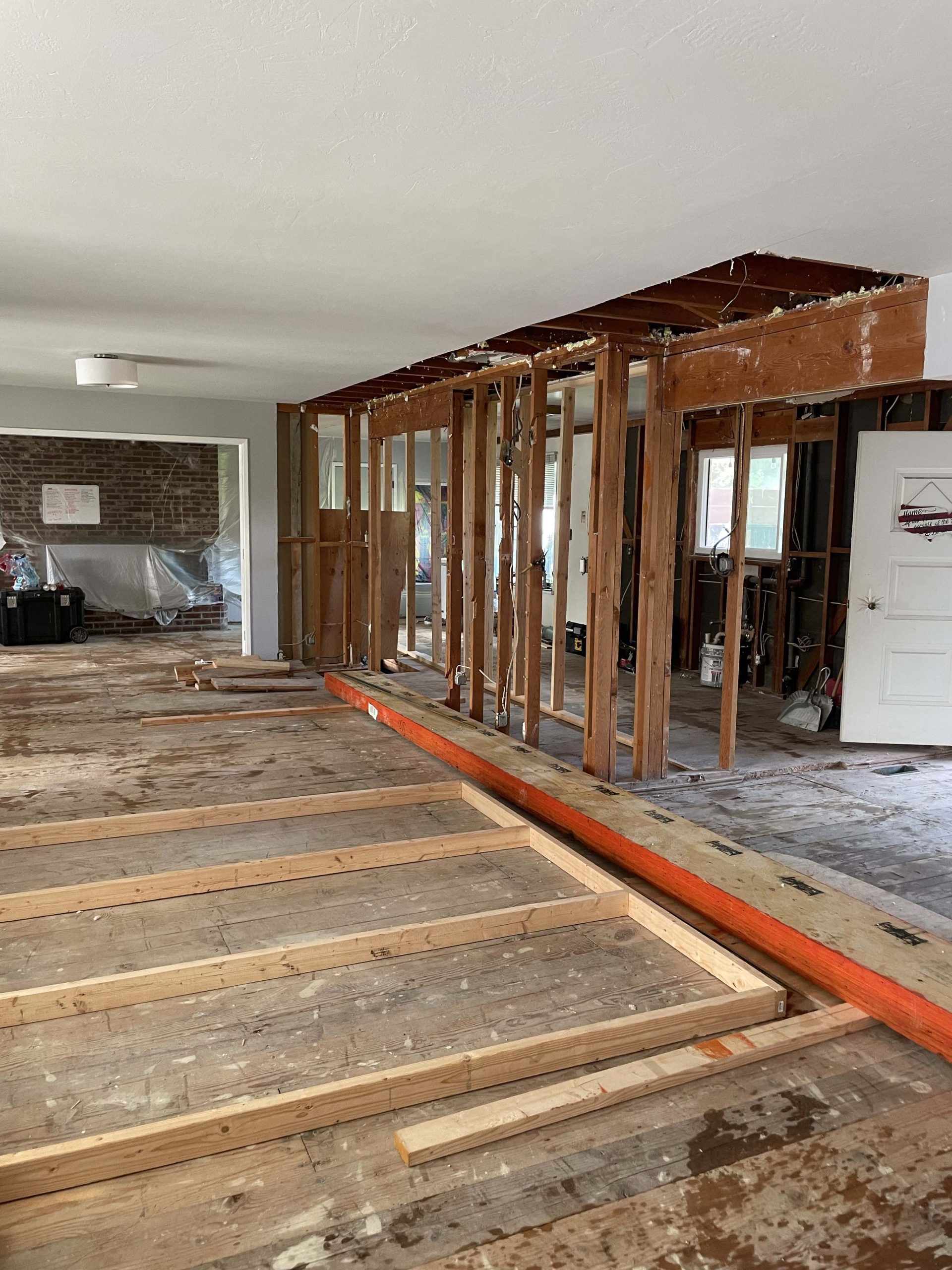 Temporary shoring and new structural framing installed to create a wide, post-free island in this Roseville kitchen remodel
