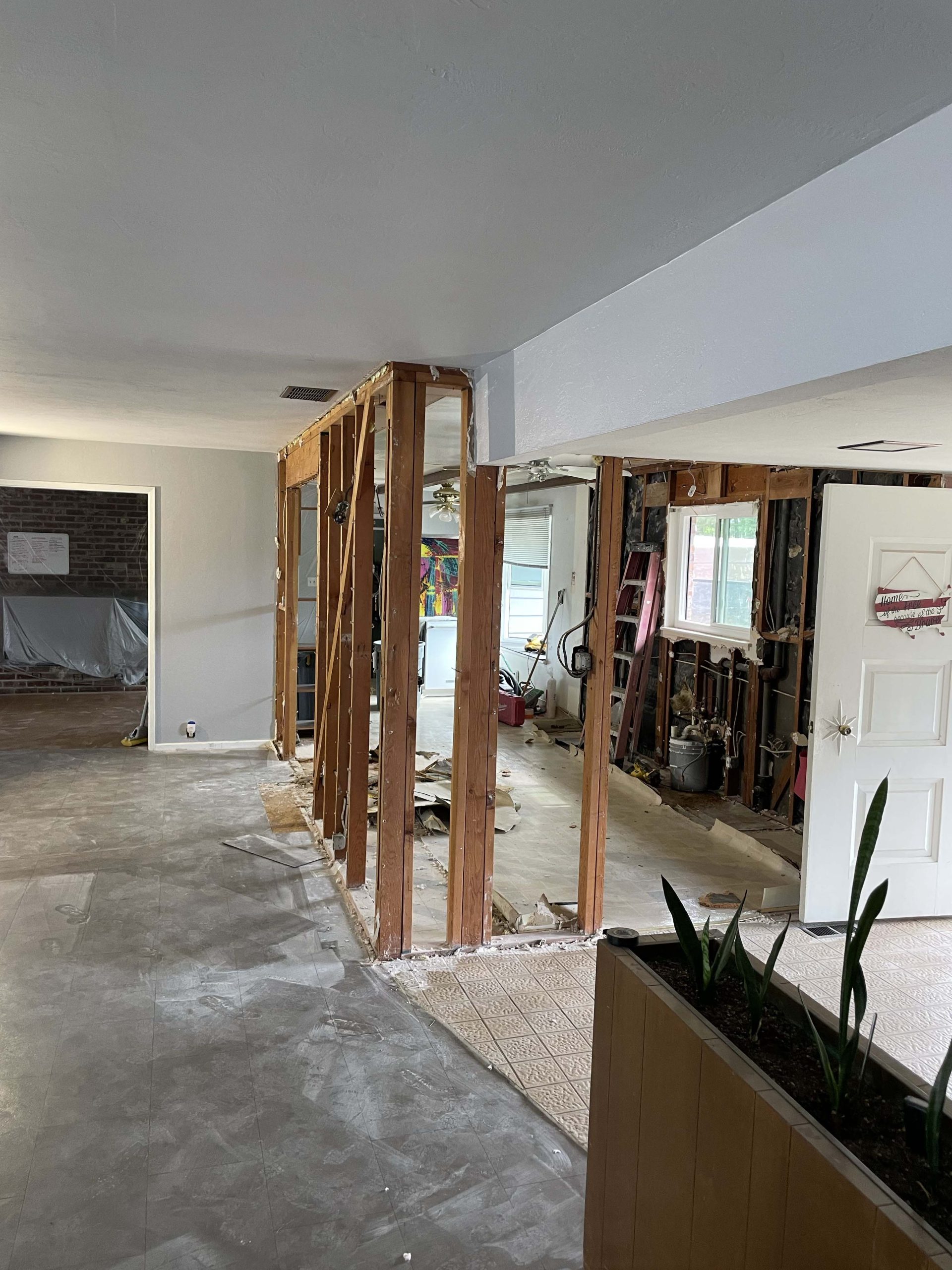 Wide view of the open framing after the structural wall was removed during this Roseville kitchen remodel by LuxeHome Construction